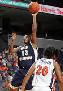 Virginia's Kristen London (20) watches as Antelia Parrish puts up a shot. (AP Photo/Andrew Shurtleff)