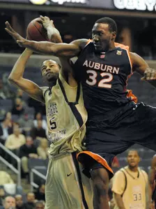 Rob Diggs tries to shoot past Auburn's Korvotney Barber during the second half.