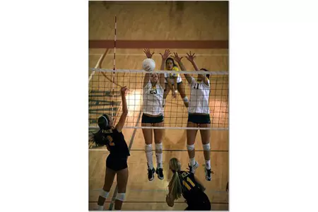 Volleyball recruits MacKenzie Knox (l) and Alyssa Valentine put up a block at Edison High School.