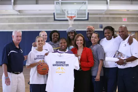 Gwendolyn (center, holding t-shirt) joined the GW women's basketball team for a <i>Wednesday's Child</i> segment on June 6. The segment will air three times this week.