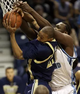 Damian Hollis battles for a rebound against Rhode Island. (AP Photo/Joe Giblin)