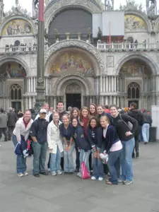 Coaches and players rest for a quick group shot in front of the Basilica of San Marco.