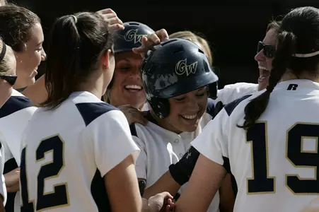 Softball celebrates as Katie Miller (middle) collects game-winning hit in the bottom of the seventh