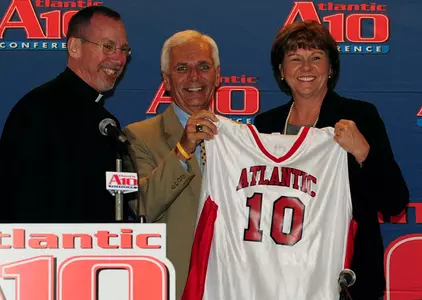 GW Director of Athletics Jack Kvancz joins Xavier president Father Michael Graham in welcoming new A-10 Commissioner, Bernadette McGlade, in Philadelphia on June 2.