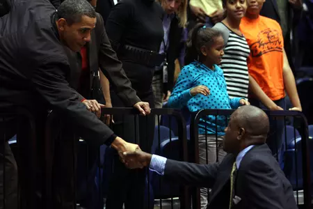 President Barack Obama shook hands with coach Karl Hobbs following Saturday's game.