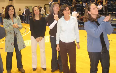 Eighteen former players and coaches were introduced at halftime of the men's basketball game.