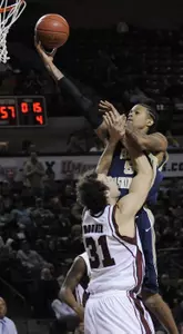 Rob Diggs, top, makes a run on the basket as Massachusetts' Luke Bonner (31) blocks in the second half. (AP Photo/Nancy Palmieri)