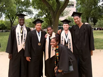 GW Basketball graduates from left, Hermann Opoku, Travis King, Jeff Alston, manager Kerishe Allen, J.P. Cotton and Damian Hollis at Commencement on the National Mall Sunday.