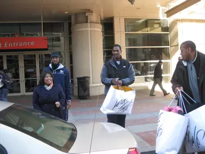 GW's Daymon Warren helps donate coats to the Children's Charities Foundation Thursday at teh Verizon Center.
