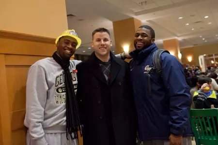 Assistant Director of Men's Basketball Operations Maurice Joseph and Director of Men's Basketball Operations Matt Lisiewski help out at Midnight Breakfast on Monday.
