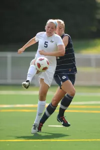 Sophomore midfielder Alex Neal fights off a Georgetown defender.