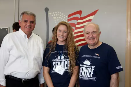 Women's water polo freshman Chandler Vilander is flanked by U.S. Secretary of Transportation Ray LaHood and GW President Steven Knapp at Freshman Day of Service on Sunday.