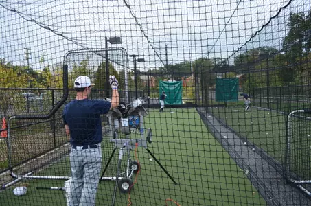GW Baseball players use new pitching machines and batting cages during the Colonials first practice of the fall season at Barcroft Park on Monday afternoon.