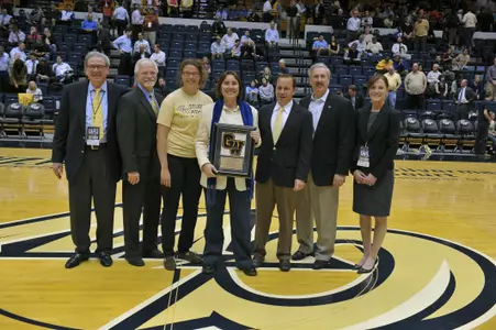 Dr. Bonnie Morris (center) was honored as the GW student-athletes' choice as Professor of the Year at Wednesday's men's basketball game against Xavier.