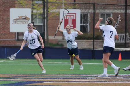 Junior Caitlyn O'Brien celebrates as GW defeats Saint Joseph's, 10-9, in overtime.
