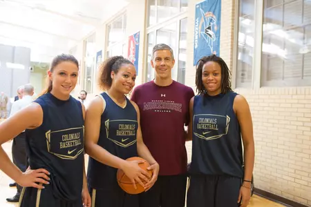 Graduate students Tara Booker and Brooke Wilson pose with Secretary of Education Arne Duncan.
