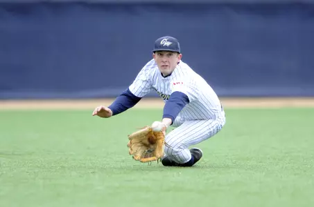 Junior Owen Beightol makes a diving catch in the field during GW's 4-2 loss against Quinnipiac on Saturday.
