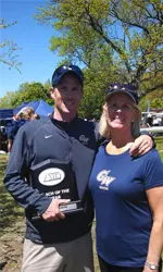 Head Coach Eric Carcich, pictured here with Senior Associate Athletic Director/SWA Mary Jo Warner, was named the Atlantic 10 Coach of the Year for the second season in a row on Saturday.