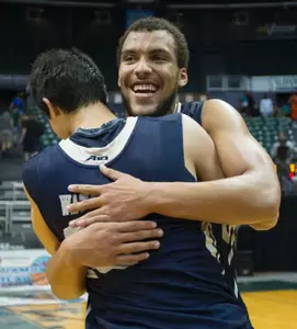 Junior Kevin Larsen and freshman Yuta Watanabe hug it out after helping GW win the 2014 Hawaiian Airlines Diamond Head Classic on Christmas Day.