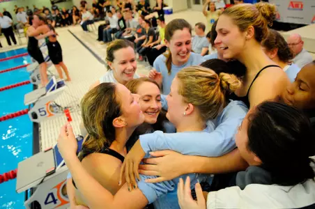 Teammates congratulate Caroline Myers after she won the 1,650 free.