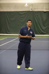Greg Munoz picked up his 100th career victory at the helm of the GW men's tennis program on Sunday against East Carolina.