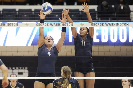Freshman Kelsey Clark (L) and Aaliya Davidson combine for a block in GW's 3-0 sweep of La Salle on Saturday.