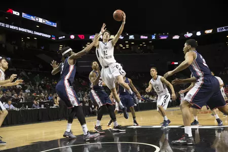 Freshman Yuta Watanabe drives in for two of his 12 points during GW's 73-55 win over Duquesne on Thursday night to advance to Friday's A-10 Championship quarterfinals.