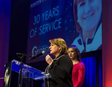 GW Gymnastics head coach Margie Foster-Cunningham accepts the Distinguished Service Award at the Georgey Awards.