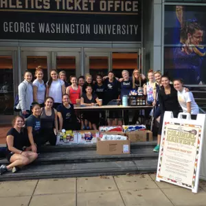 Members of the GW Lacrosse team pose for a photo at Colonial Harvest 2015
