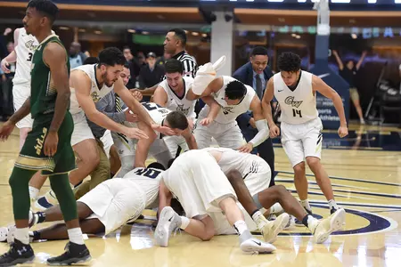 The Colonials react after defeating USF on Collin Smith's game-winning three-pointer