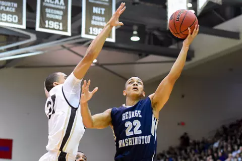 Feb 13, 2016; St. Bonaventure, NY, USA; George Washington Colonials guard Joe McDonald (22) shoots the ball against the defense of St. Bonaventure Bonnies forward Dion Wright (21) during the second half at the Reilly Center. St. Bonaventure defeated George Washington 64-57. Mandatory Credit: Rich Barnes-USA TODAY Sports