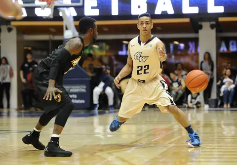 Colonials guard Joe McDonald (22) passes the ball as Virginia Commonwealth Rams guard JeQuan Lewis (1) looks on during the first half at Charles E. Smith Center. Credit: Brad Mills-USA TODAY Sports