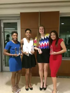Lauren Chase, Brianna Cummings, Kelsi Mahoney and Mei-Lyn Bautista show off their hardware.