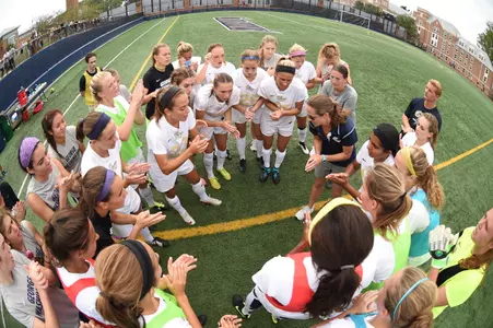 Women's soccer huddles