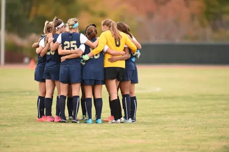 Women's soccer huddles