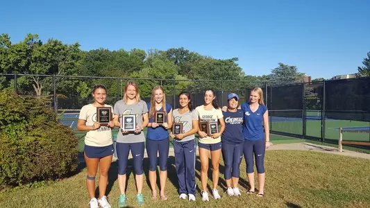 Women's Tennis Holding trophies