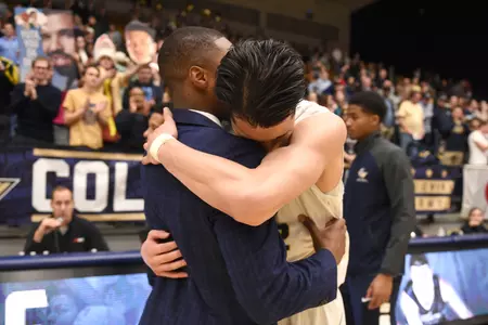 Yuta Watanabe embraces with head coach Maurice Joseph following the Senior Night win over Fordham