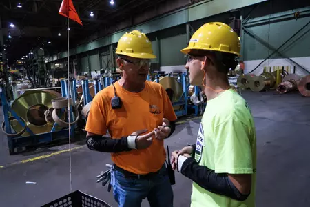 Alexy Boehm (right) has a summer internship at PMX Industries in his native Iowa.