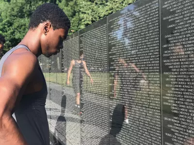 Terry Nolan Jr. selects the name of a fallen soldier on the Vietnam War Memorial Wall