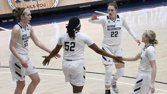 Faith Blethen, Alexandra Maund, Maddie Loder and Tori Hyduke high five.
