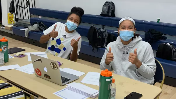 Jasmine Whitney and Essence Brown participate in the GW Athletics Hour of Action