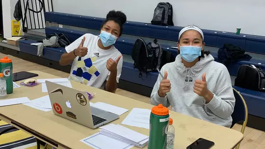 Jasmine Whitney and Essence Brown participate in the GW Athletics Hour of Action