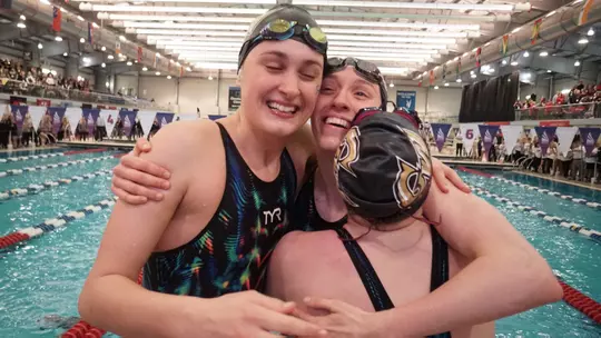 GW women's swimmers celebrate a win at the A-10 Championships in 2019