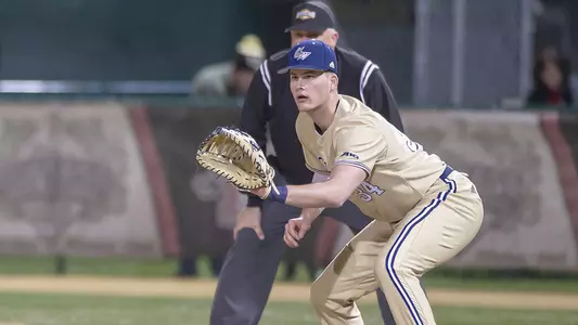 Derek Ripp holds a runner on at first base.