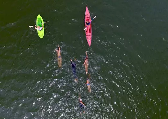 Moritz Fath swims with his family in the Tennesse River