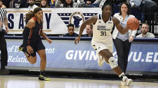 Mayowa Taiwo dribbles away from a Dayton defender.