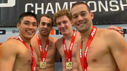Tyler Kawakami, Youssef Ragab, Dylan Arzoni and Moritz Fath celebrate their gold medal in the 400 free relay