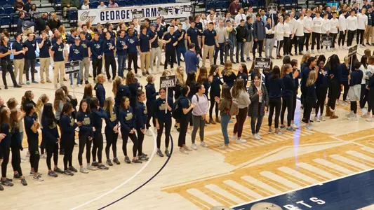 Student-Athletes are recognized on-court during a women's basketball game for making it onto the dean's list.