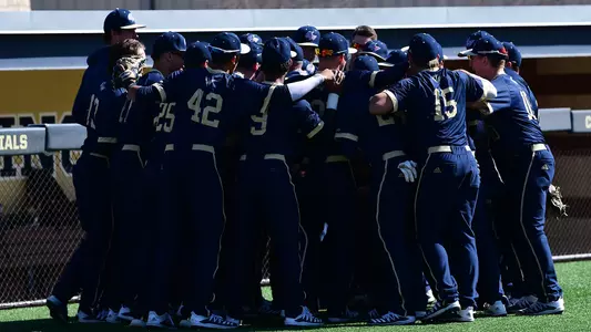 The baseball team huddles prior to a game.