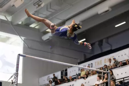 Deja Chambliss competes on bars.